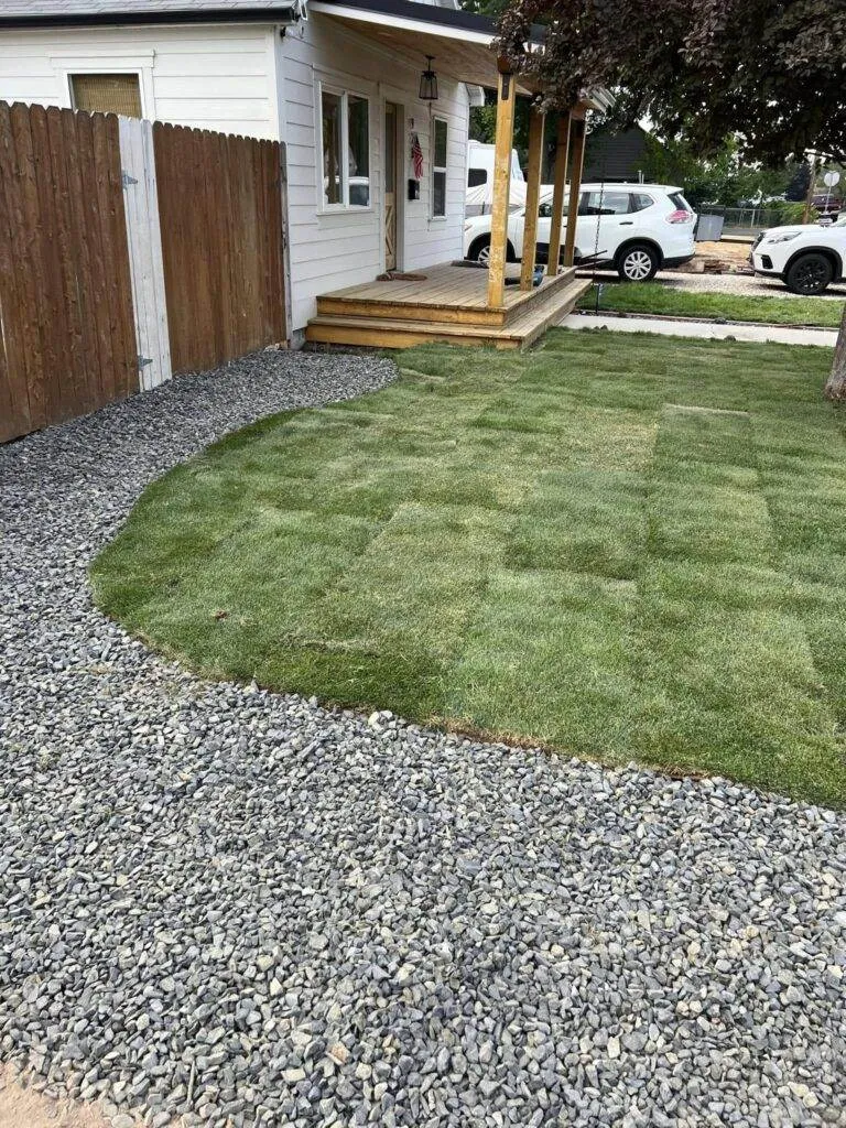 a house with a porch and a gravel driveway